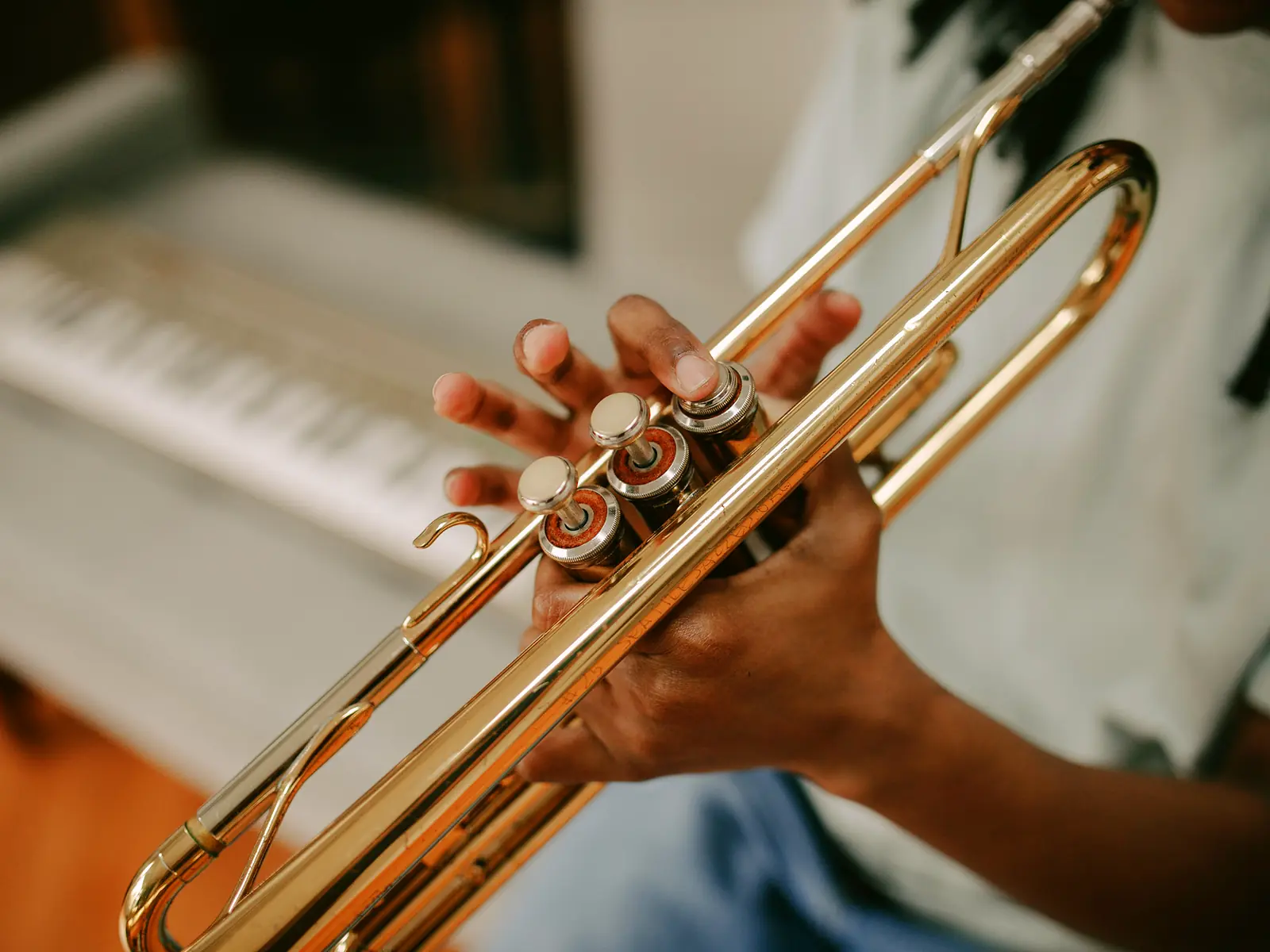 Close-up of a student's hands on the valves of a brass trumpet